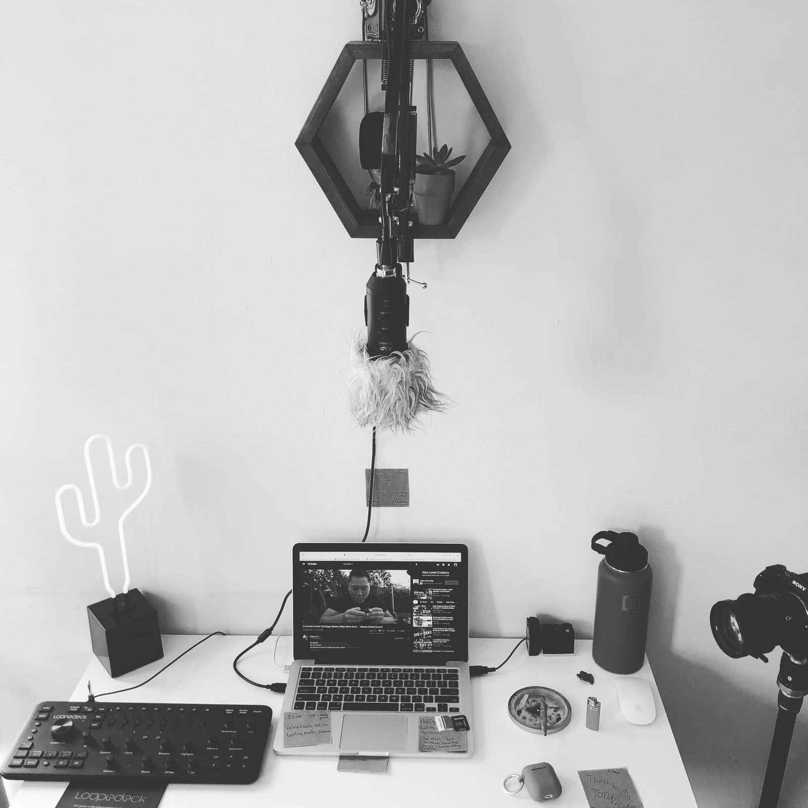 A home recording workspace with a laptop and suspended microphone; not a PowerMic.
